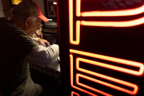 Tom Rehkopf, 82, works on a typewriter at his home workshop in Roswell on October 25, 2025. Rehkopf has collected around 1,000 typewriters. (Arvin Temkar / AJC)