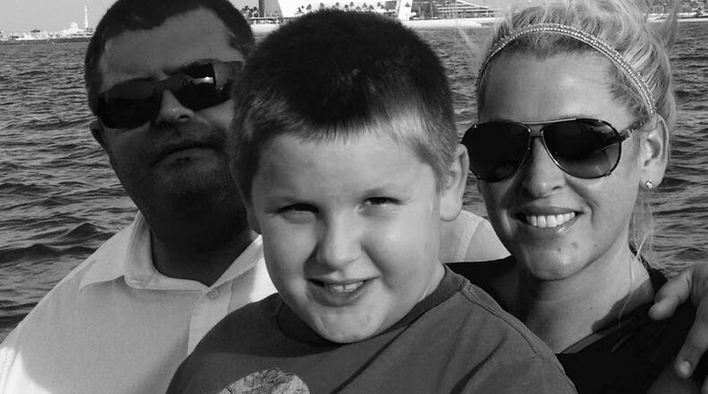 Scott Darden, son Eesa and wife Diana in front of the Burj Al Arab hotel in Dubai in 2015. (Washington Post, courtesy of Darden family)