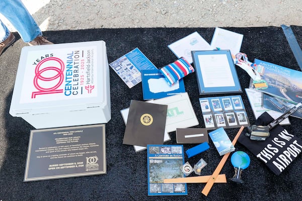 More than 20 items that tell the story of the airport's  evolution are on display before they go into the time capsule on the airfield at Stogner Hill at Hartsfield-Jackson Atlanta International Airport on Tuesday, Sep. 8, 2026. The event commemorates ATL’s 100th anniversary. (Miguel Martinez/ AJC)