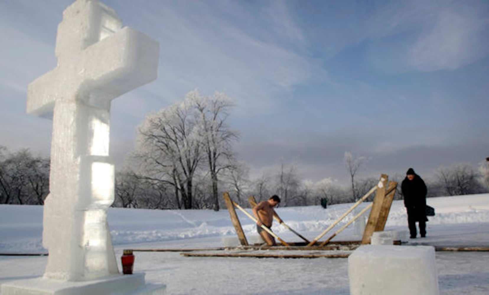 Think it's cold? Russians plunge into ice bath