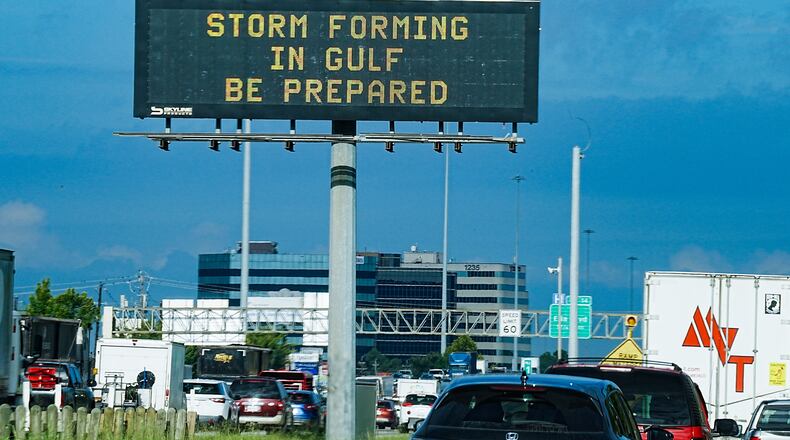 Motorists drive by Texas Department of Transportation signs on I-610 as Tropical Storm Edouard approaches in Houston, Tuesday, Sept. 1, 2026. (Elizabeth Conley/Houston Chronicle via AP)