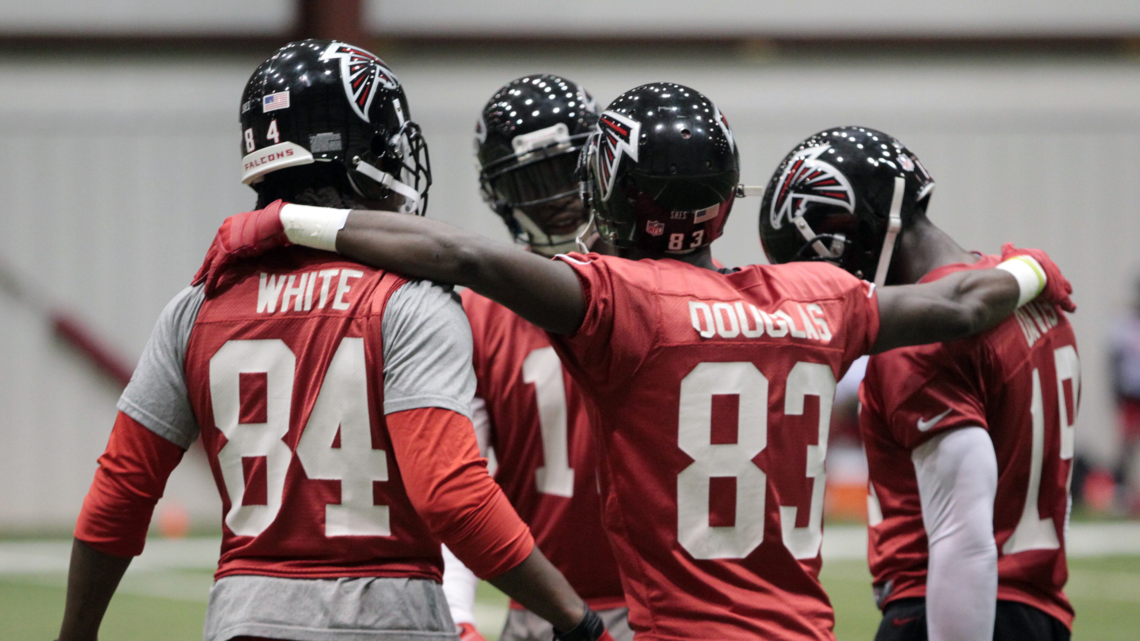 In this 2013 photo, former Falcons wide receivers Roddy White (from left), Julio Jones, Harry Douglas and Drew Davis huddle up during team practice for the NFC Championship game against San Francisco at Flowery Branch. (Curtis Compton/AJC)