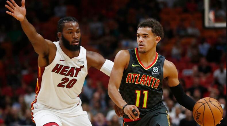 Trae Young drives against Miami's Justice Winslow during Monday's game. (AP Photo/Brynn Anderson)
