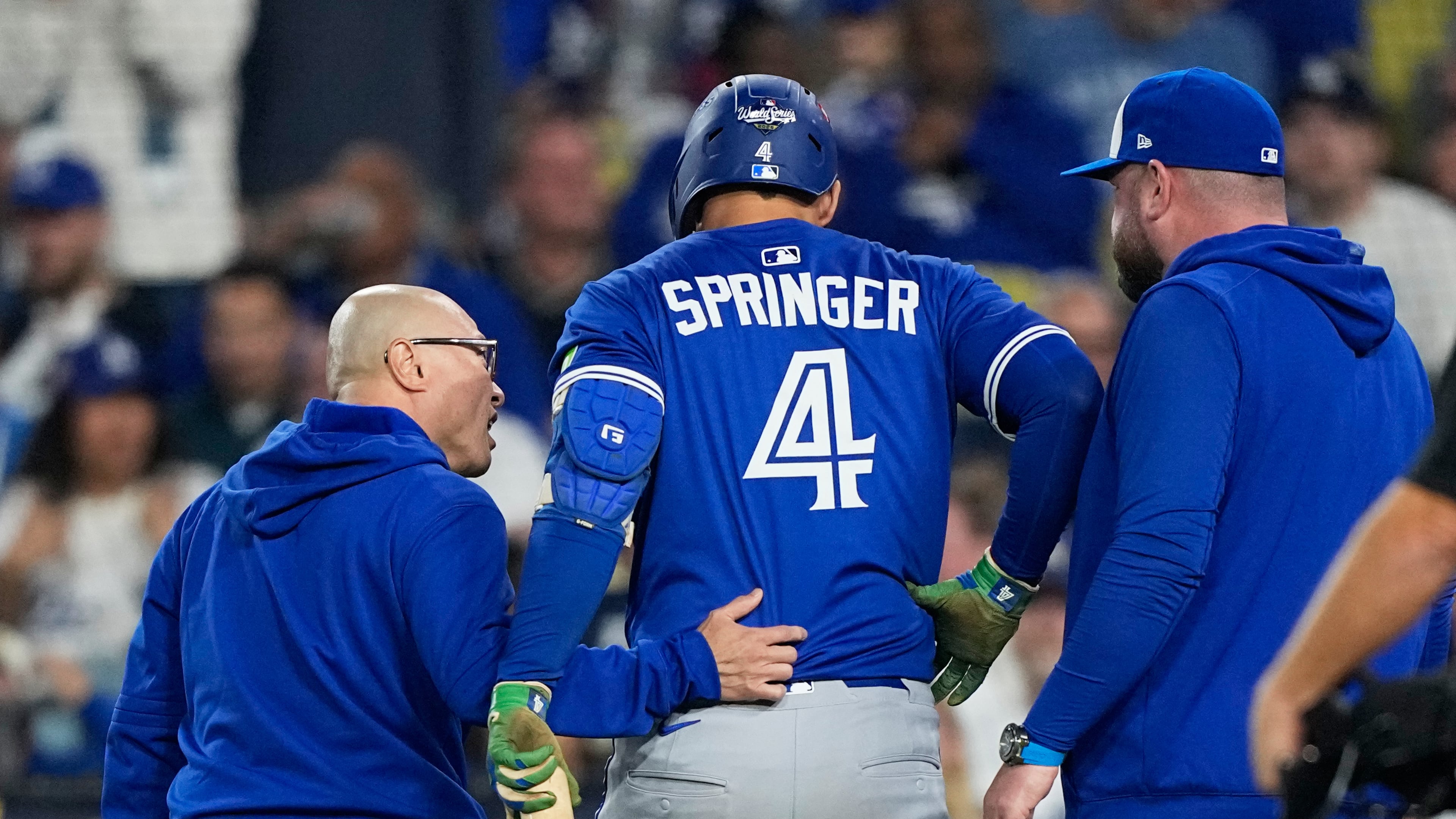 Toronto Blue Jays' George Springer leaves the game with an injury during the seventh inning in Game 3 of baseball's World Series against the Los Angeles Dodgers, Monday, Oct. 27, 2025, in Los Angeles. (AP Photo/Brynn Anderson)