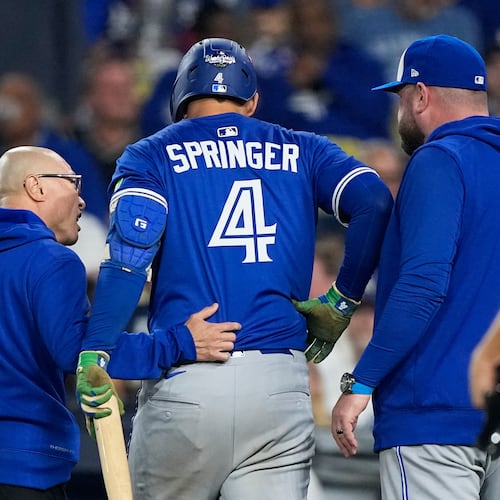 Toronto Blue Jays' George Springer leaves the game with an injury during the seventh inning in Game 3 of baseball's World Series against the Los Angeles Dodgers, Monday, Oct. 27, 2025, in Los Angeles. (AP Photo/Brynn Anderson)