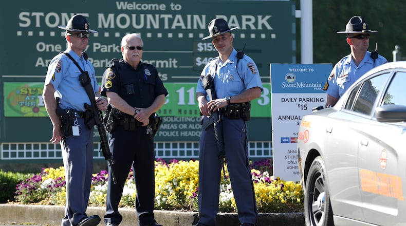 Georgia State Patrol troopers with long guns monitor the entrance to Stone Mountain Park on Saturday morning, April 23, 2016 where a white power protest and two counter protests were scheduled. Ben Gray / bgray@ajc.com