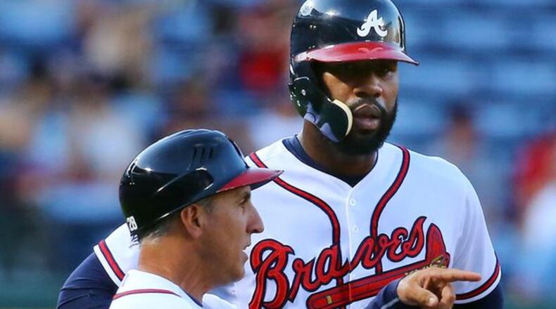 Jason Heyward is 6-for-8 against Friday's Cubs starter Jason Hammel. Heyward is also really large, as this photo of him next to third-base coach Doug Dascenzo illustrates. (Curtis Compton/AJC)
