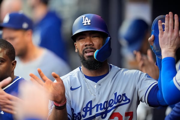 Los Angeles Dodgers' Teoscar Hernández (37) celebrates a run off the batt of Los Angeles Dodgers third baseman Max Muncy (13) in the fourth inning of a baseball game against the Atlanta Braves, Sunday, May 4, 2025, in Atlanta. (AP Photo/Mike Stewart)