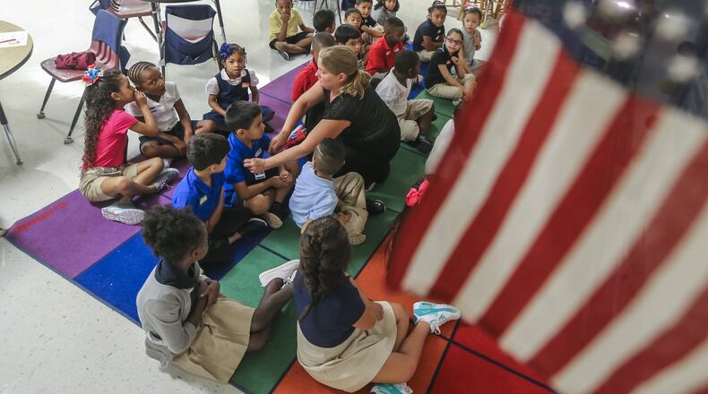 August 1, 2016 Cobb County: Stephanie Laurens (center) gets her first graders situated on their first day of class at Argyle Elementary School in Smyrna. JOHN SPINK /JSPINK@AJC.COM