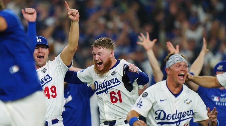 Winning Los Angeles Dodgers pitcher Will Klein (61) celebrates with Blake Treinen (49) and Alex Call (12) during 18th inning Game 3 World Series playoff MLB baseball action in Los Angeles on Monday, Oct. 27, 2025. (Frank Gunn/The Canadian Press via AP)