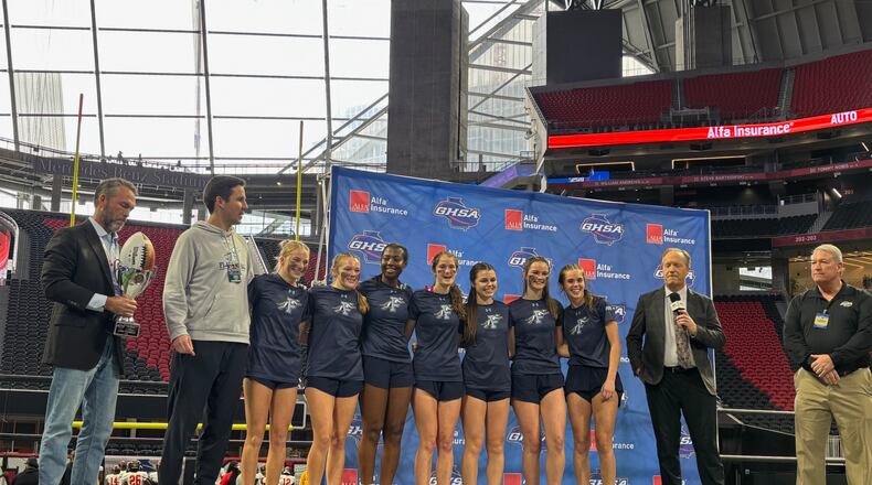 The Pope flag football team celebrates their Division 3 championship win on Dec. 17, 2024, at Mercedes-Benz Stadium. Pope defeated Pace Academy 19-6