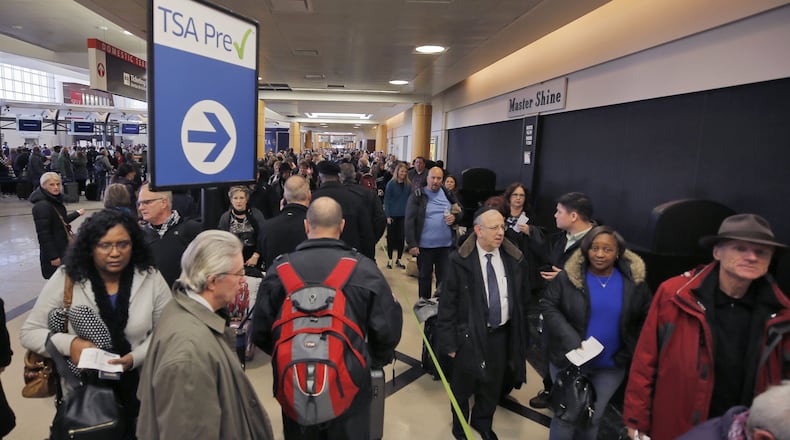 Security lines wrap through the atrium and around the baggage areas of Hartsfield-Jackson International Airport. BOB ANDRES /BANDRES@AJC.COM