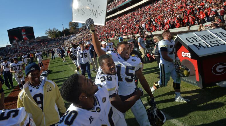Georgia Tech defensive back A.J. Gray (15) holds a sign to celebrate their 28-27 win over Georgia at Sanford Stadium on Saturday, November 26, 2016. HYOSUB SHIN / HSHIN@AJC.COM