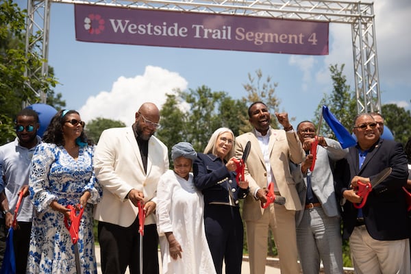 Atlanta elected officials (including Mayor Andre Dickens, center) cut the ribbon on the 1.3-mile Westside Trail–Segment 4 of the Beltline at Washington Park on June 23, 2025.  (Riley Bunch/AJC)