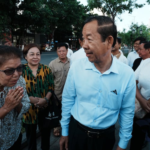 Supporters greet Rong Chhun, a prominent Cambodian opposition politician, center, as he arrives at his hearing at the Supreme Court in Phnom Penh, Cambodia, Monday, June 15, 2026. (AP Photo/Heng Sinith)