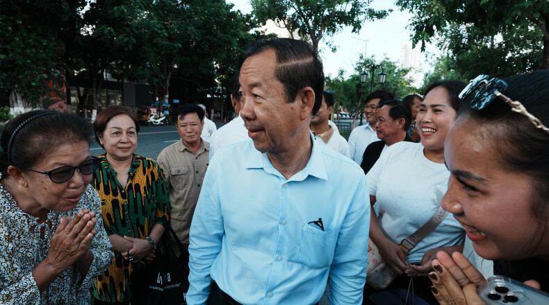 Supporters greet Rong Chhun, a prominent Cambodian opposition politician, center, as he arrives at his hearing at the Supreme Court in Phnom Penh, Cambodia, Monday, June 15, 2026. (AP Photo/Heng Sinith)