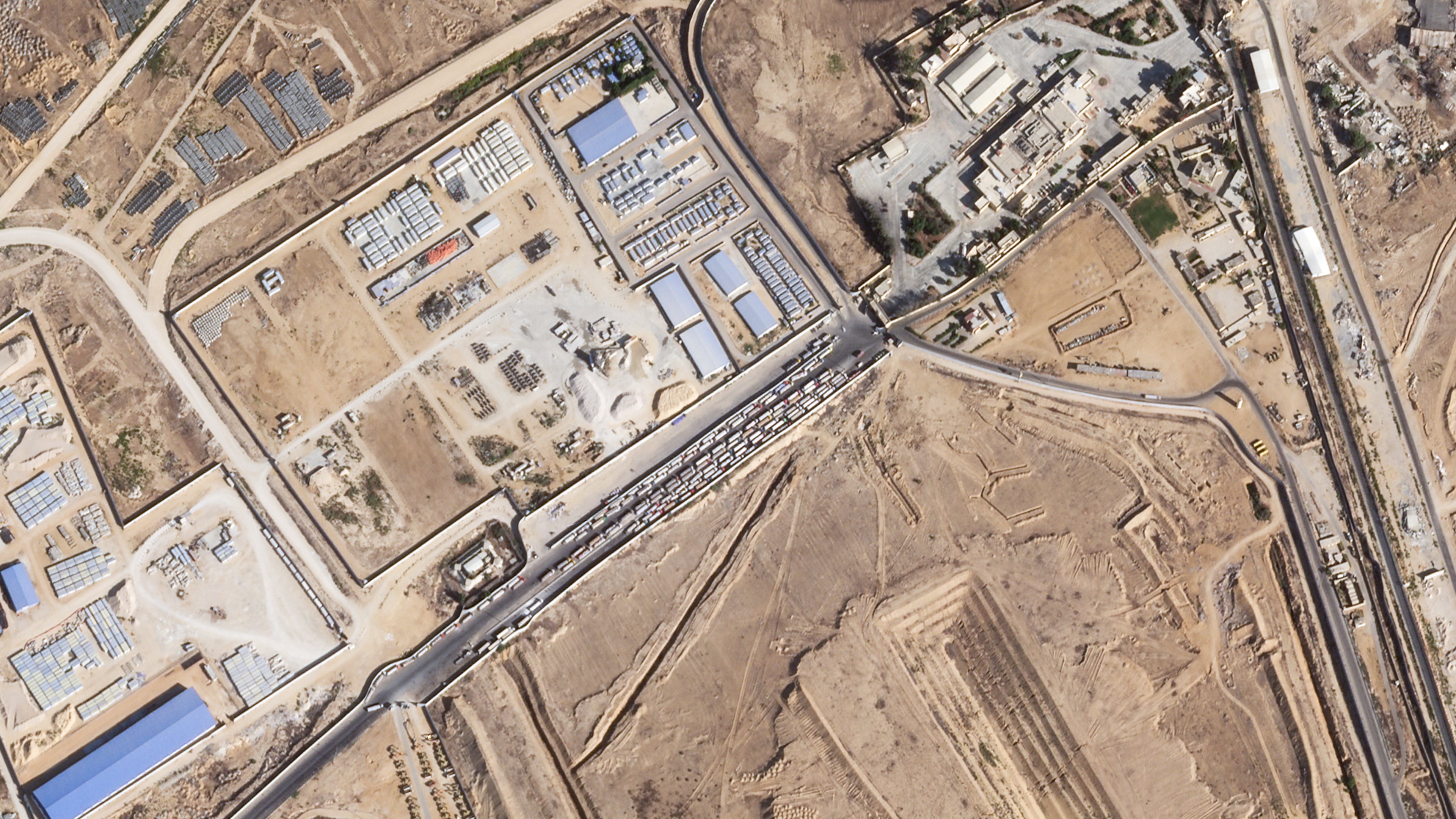 This satellite photo from Planet Labs PBC shows trucks lined up on the Egyptian side of the Rafah border crossing with the Gaza Strip on Thursday, Oct. 16, 2025. (Planet Labs PBC via AP)