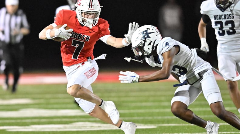 North Gwinnett QB Dylan Hall makes a defender miss as he picks up yardage. in his team's 27-21 win over Norcross, Oct. 25, 2024. (Jim Blackburn for the AJC)