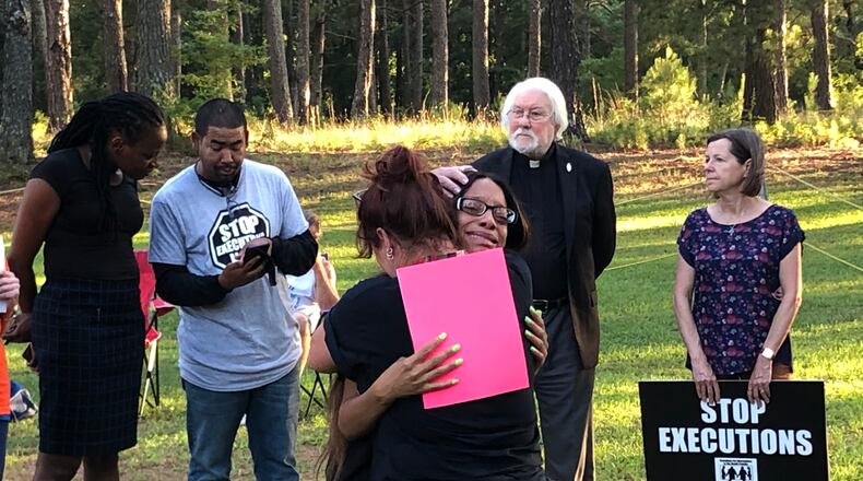 Tykecia Wilson sobs while hugging a protester as her father's execution nears.