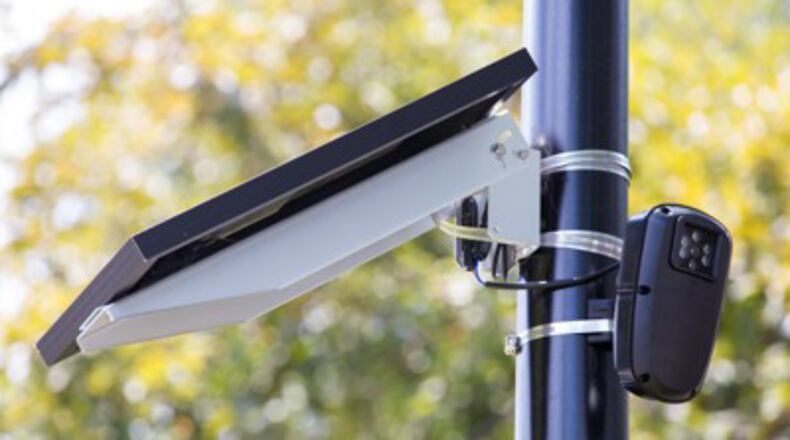 A Flock camera at work. Alpharetta has signed a five-year agreement with Flock Group Inc. to give police access to automated license plate reader data. CASEY SYKES / AJC FILE