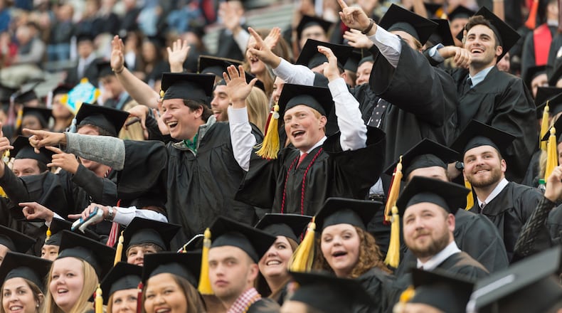 May 5, 2017, Athens - Students cheer during the University of Georgia's undergraduate commencement ceremony at Sanford Stadium in Athens, Georgia, on Friday, May 5, 2017. (DAVID BARNES / DAVID.BARNES@AJC.COM)