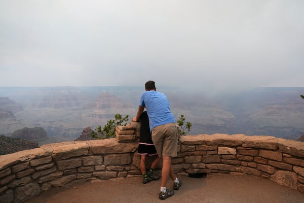 Smoke from the Dragon Bravo Fire moves over the Grand Canyon from the North Rim, Monday, July 14, 2025, in Grand Canyon National Park, Ariz. (AP Photo/Ross D. Franklin)