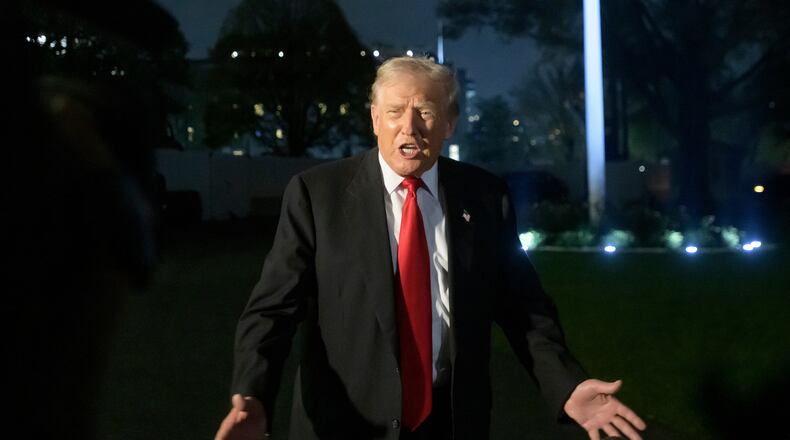 President Donald Trump talks with reporters upon his arrival at the White House in Washington, Sunday, Nov. 9, 2025. (AP Photo/Rod Lamkey, Jr.)