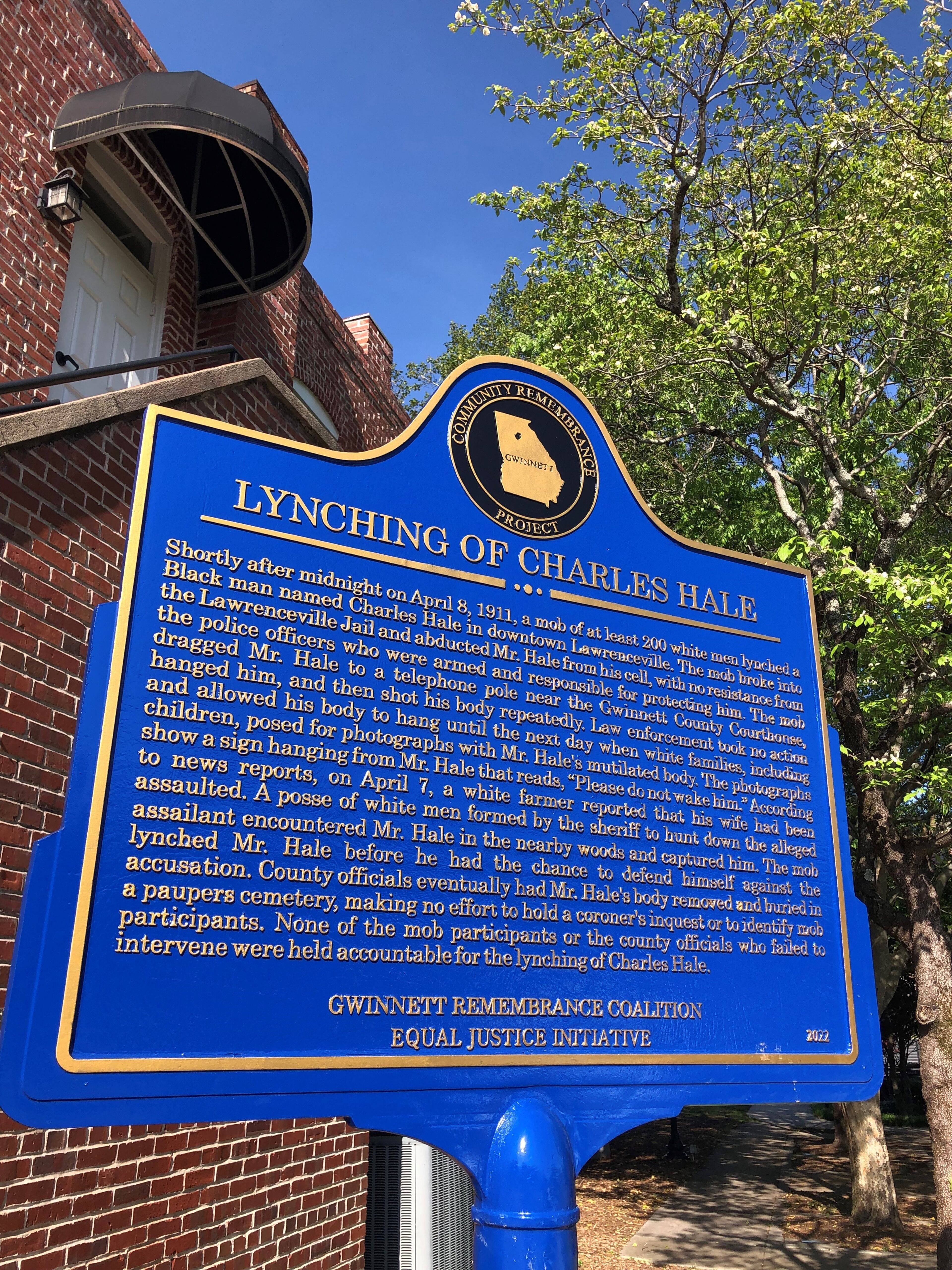 A plaque to commemorate Charles Hale stands where he was lynched in 1911, on the same corner of Lawrenceville square where a monument to the Confederacy once stood. (Alia Pharr/AJC)