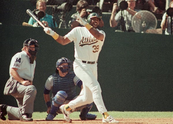 FILE - Oakland Athletics' Dave Parker (39) watches the ball fly over the right center field wall for a sixth inning solo home run in Game 2 of the American League Championship baseball series against the Toronto Blue Jays, at Oakland, Calif., Oct. 4, 1989. (AP Photo/John Gaps III, File)