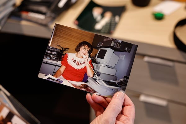 Patti Young, executive assistant to Peach Bowl CEO and president Gary Stokan, shares a photo of herself working in the early 1990s. She has worked for the Peach Bowl for 56 years. (Natrice Miller/AJC)