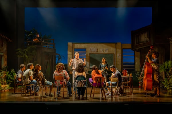 The musicians lend an ear to their teacher, Mario (Kevin Del Aguila). (Greg Mooney/Courtesy of Alliance Theatre)