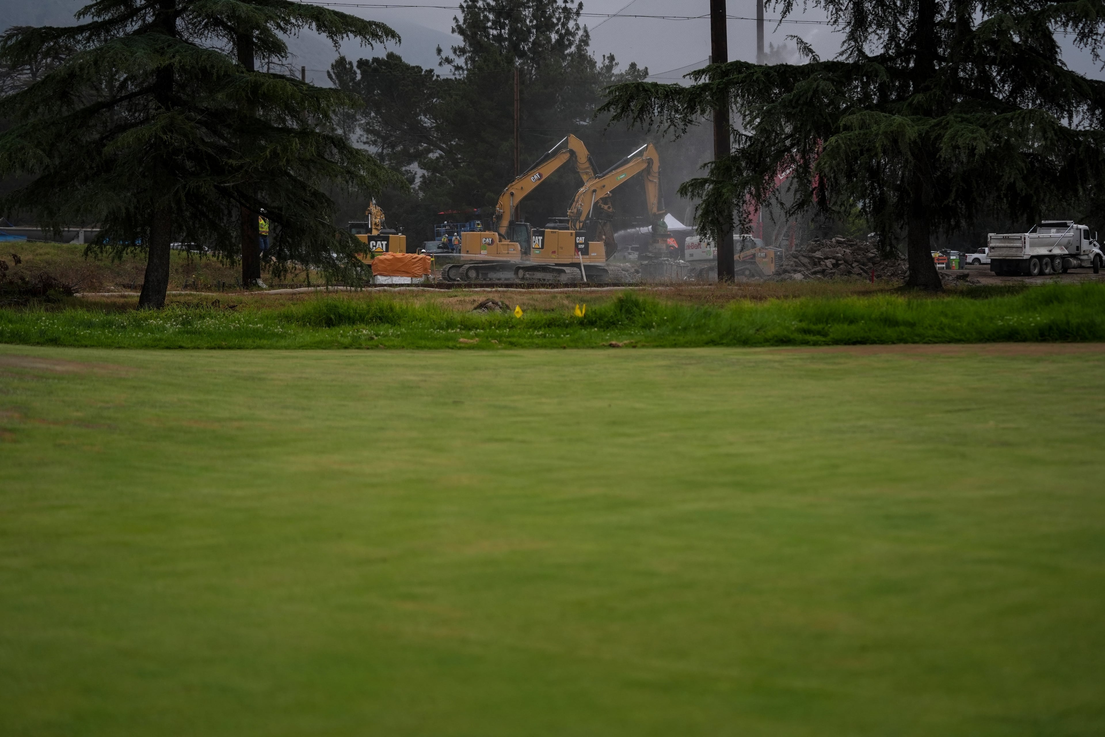 Debris from January wildfires is processed at a recycling facility set up on a golf course in Altadena, Calif., Wednesday, June 4, 2025. (AP Photo/Jae C. Hong)