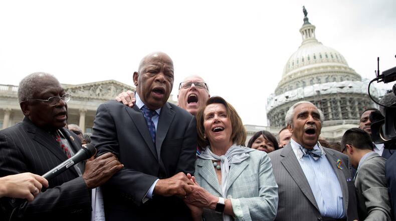 From left, House Assistant Minority Leader James Clyburn of S.C., Rep. John Lewis, D-Ga., Rep. Joseph Crowley, D-N.Y., House Minority Leader Nancy Pelosi of Calif. and Rep. Charles Rangel, D-N.Y., sing "We Shall Overcome" on Capitol Hill in Washington, Thursday, June 23, 2016, after House Democrats ended their sit-in protest. (AP Photo/Carolyn Kaster)