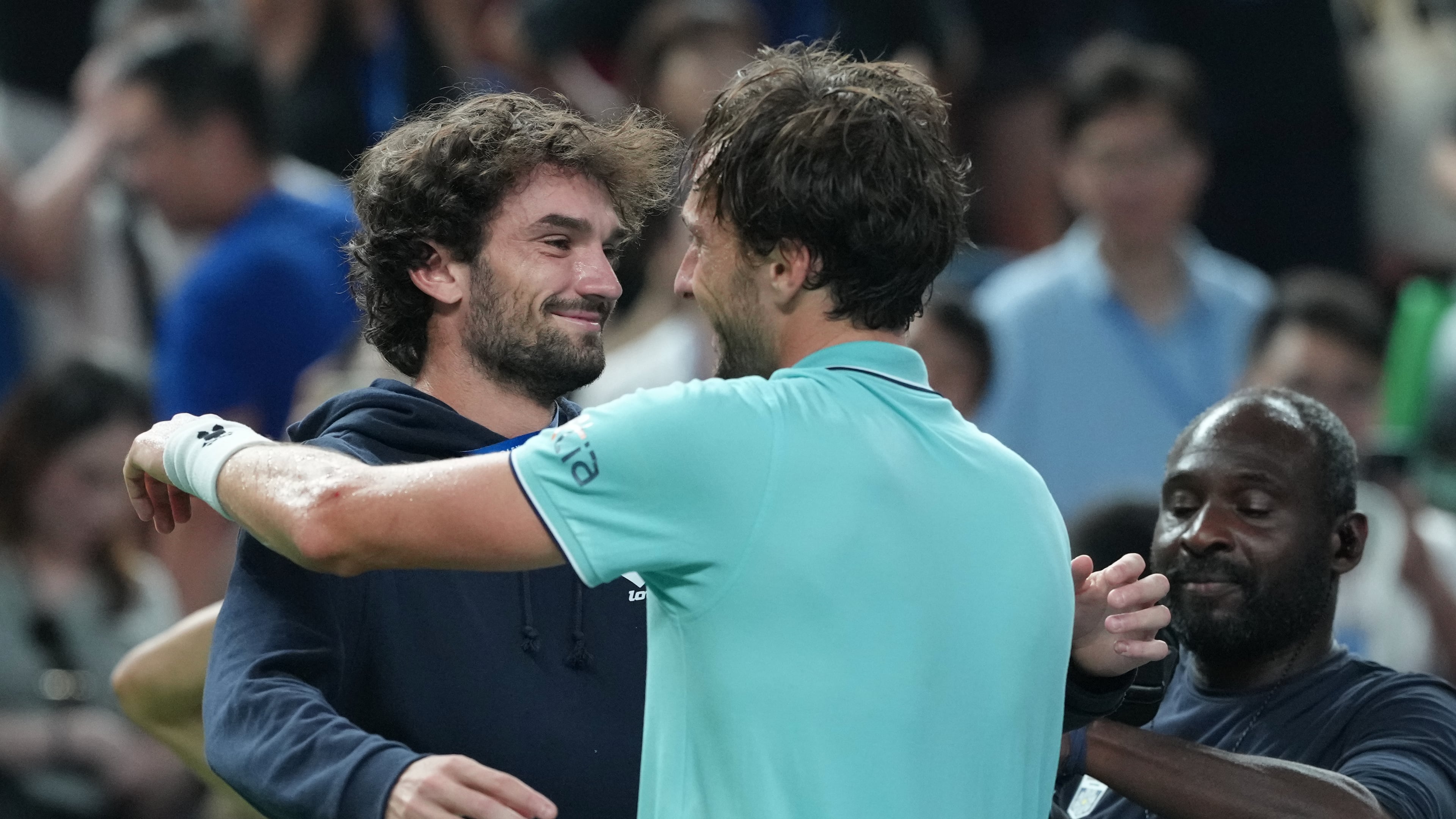 Arthur Rinderknech of France, right, is greeted by his cousin Valentin Vacherot of Monaco after defeating Daniil Medvedev of Russia in the men's singles semifinal match of the Shanghai Masters tennis tournament at Qizhong Forest Sports City Tennis Center, in Shanghai, China, Saturday, Oct. 11, 2025. (AP Photo/Andy Wong)
