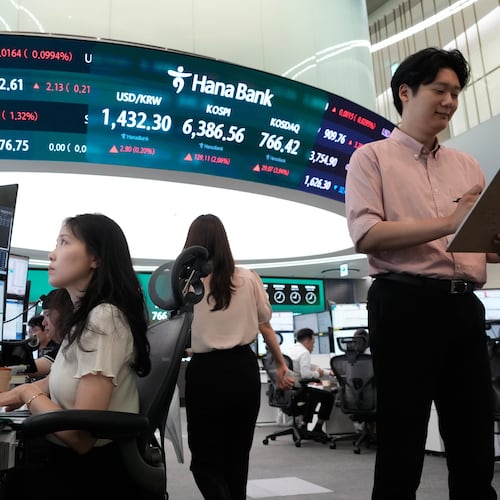 Currency traders work at the foreign exchange dealing room of the Hana Bank headquarters in Seoul, South Korea, Tuesday, Aug. 4, 2026. (AP Photo/Ahn Young-joon)