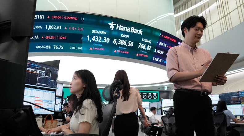 Currency traders work at the foreign exchange dealing room of the Hana Bank headquarters in Seoul, South Korea, Tuesday, Aug. 4, 2026. (AP Photo/Ahn Young-joon)