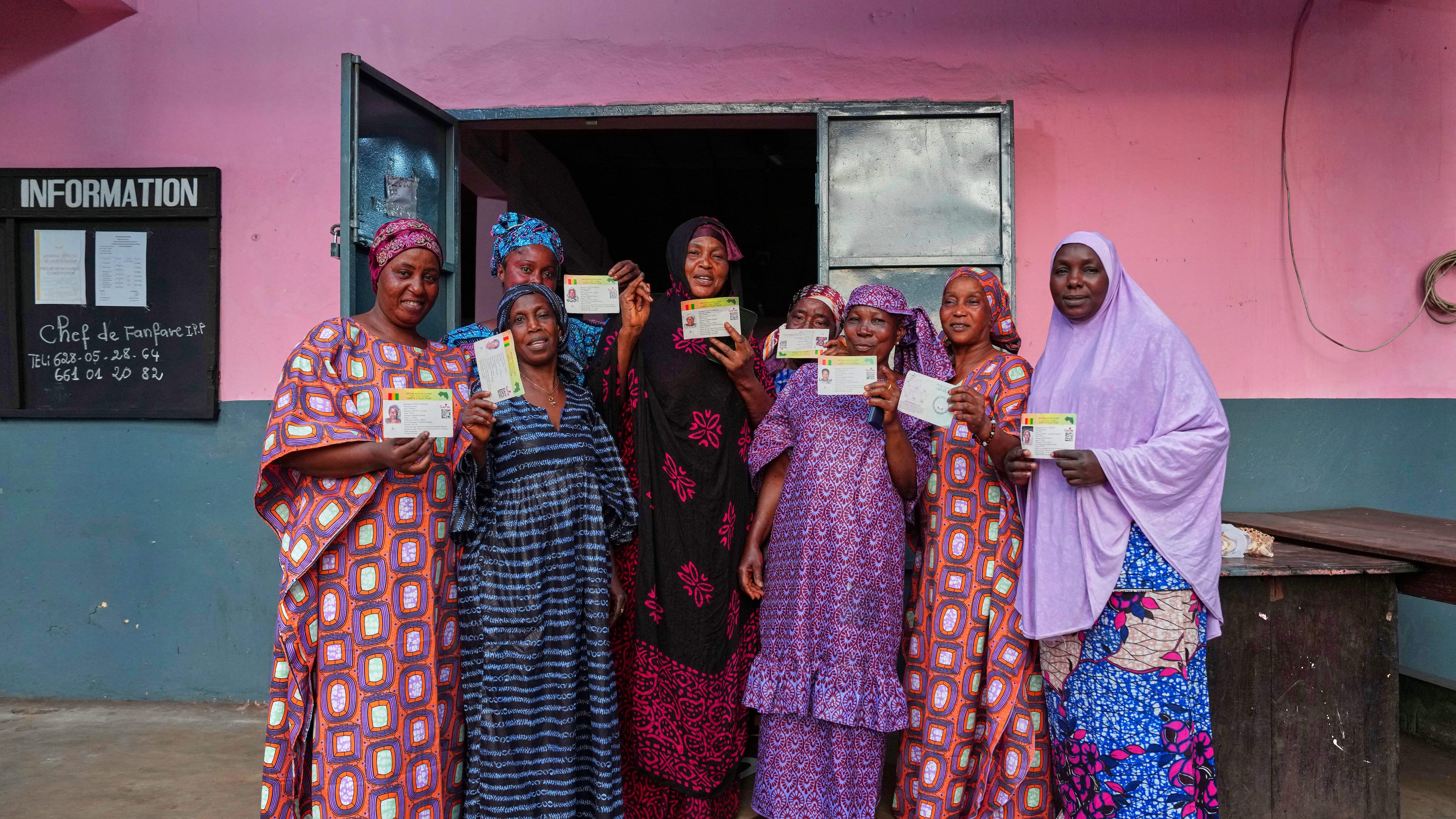 A group of women pose at a polling station after casting their votes during the constitutional referendum in Conakry, Guinea, Sunday, Sept. 21, 2025. (AP Photo/Misper Apawu)