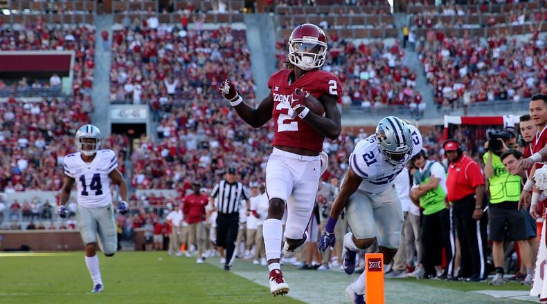 Oklahoma Sooners wide receiver CeeDee Lamb (2) runs for a touchdown past Kansas State Wildcats defensive back Kevion McGee (14) during the second half at Gaylord Family - Oklahoma Memorial Stadium.