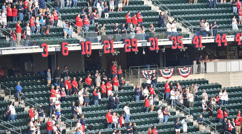 Fans stand as Timothy Miller, an operatic tenor, performs the national anthem before the Atlanta Braves' home opener Friday, April 9, 2021, at Truist Park in Atlanta. (Hyosub Shin / Hyosub.Shin@ajc.com)