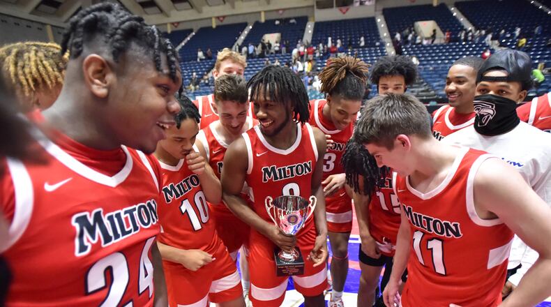 March 13, 2021 Macon - Milton's Bruce Thornton (2) holding the Championship trophy celebrates their victory over Berkmar during the 2021 GHSA State Basketball Class AAAAAAA Boys Championship game at the Macon Centreplex in Macon on Saturday, March 13, 2021 Milton won 52-47 over Berkmar. (Hyosub Shin / Hyosub.Shin@ajc.com)