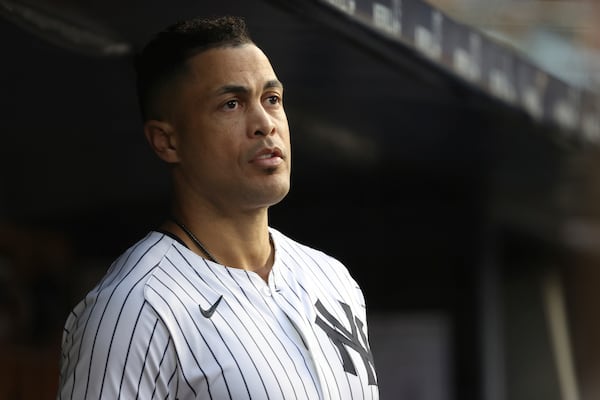 New York Yankees' Giancarlo Stanton stands in the dugout during the second inning of a baseball game against the Los Angeles Angels, Monday, June 16, 2025, in New York. (AP Photo/Pamela Smith)