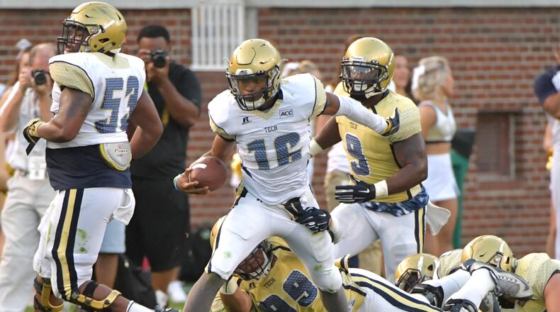 Georgia Tech white-team quarterback TaQuon Marshall (16) runs past gold-team defensive lineman Desmond Branch (99) during the Georgia Tech spring game at Bobby Dodd Stadium on Friday, April 21, 2017. HYOSUB SHIN / HSHIN@AJC.COM
