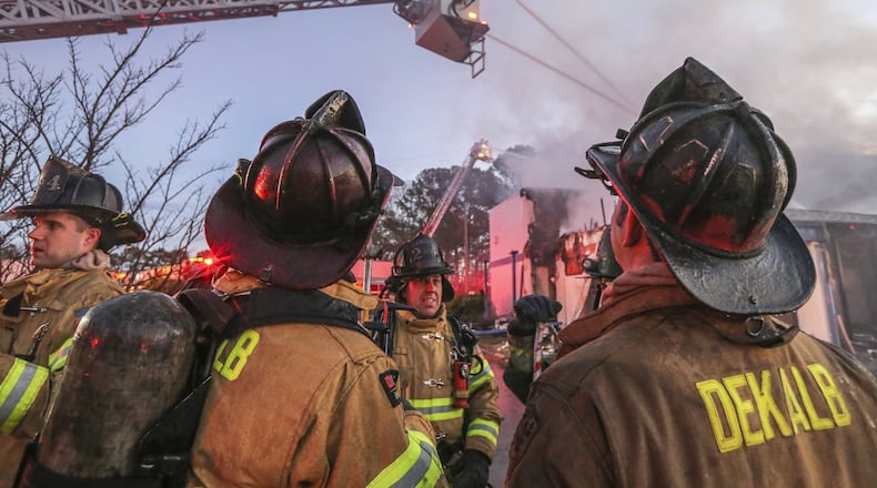DeKalb County’s government might not have been eligible for the $150,000 it collected from the federal government to hire 34 firefighters, according to a report by DeKalb Ethics Officer Stacey Kalberman. In this Jan. 9 photo, DeKalb firefighters are on the scene of a massive fire that ripped through an abandoned doctor’s office near South Hairston and Redan roads. JOHN SPINK /JSPINK@AJC.COM