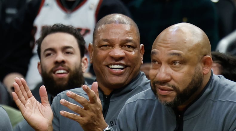 FILE - Milwaukee Bucks head coach Doc Rivers, center, applauds during the first half of an NBA basketball game against the Dallas Mavericks, March 31, 2026, in Milwaukee. (AP Photo/Jeffrey Phelps, File)