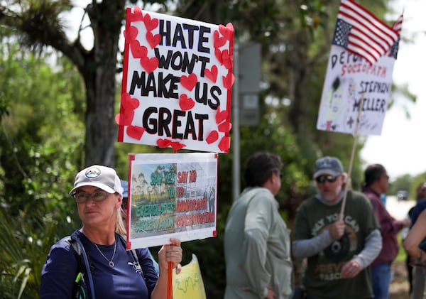 A protester stands outside the migrant detention facility dubbed "Alligator Alcatraz" at the Dade-Collier Training and Transition Facility, Saturday, July 12, 2025, in Ochopee, Fla. (AP Photo/Alexandra Rodriguez)
