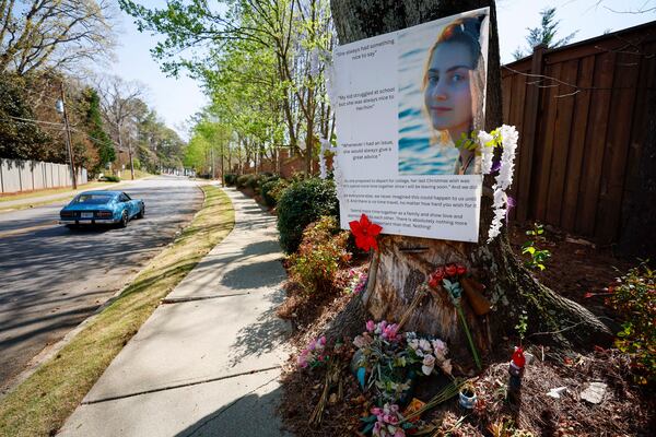 A memorial for Sophia Lekiachvili stands at the curve on Oak Grove Road, where she was fatally injured as a passenger in a car crash in February 2024. (Miguel Martinez/AJC)
