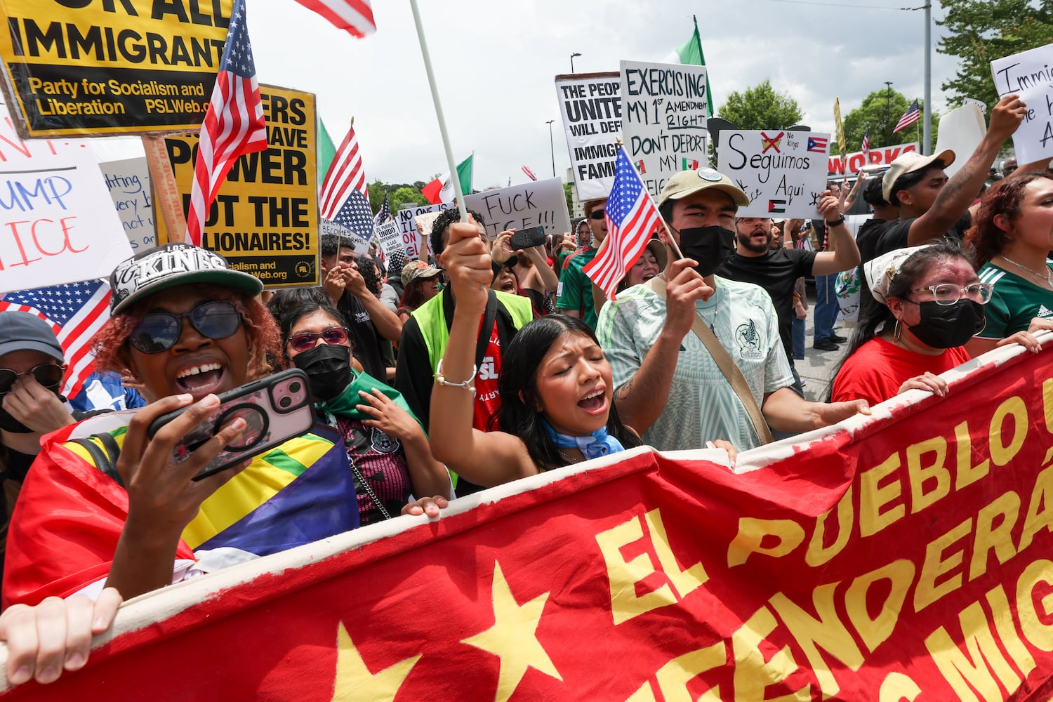 Demonstrators chant as police block their marching route during a protest on ICE raids and deportation arrests on Chamblee Tucker Road in Atlanta on Saturday, June 14, 2025. (Arvin Temkar / AJC)
