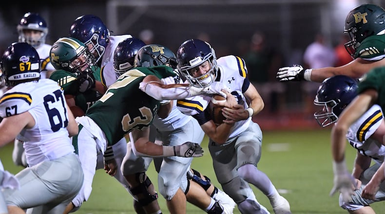Marist's Champ Davis (10) gets tackled by Blessed Trinity's Mavrick Torrico (32) in the second half at Blessed Trinity Catholic High School in Roswell on Friday, August 27, 2021. Marist won 28-13 over Blessed Trinity. (Hyosub Shin / Hyosub.Shin@ajc.com)