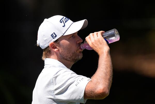 Russell Henley hydrates as he walks the eighth hole during the first round of the RBC Heritage golf tournament, Thursday, April 17, 2025, in Hilton Head Island, S.C. (AP Photo/Mike Stewart)