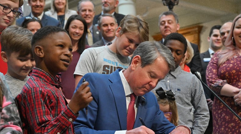 Gov. Brian Kemp signs legislation that allows parents who don’t want their children wearing masks to opt out of any school district mandates at the Georgia State Capitol on Tuesday, March 29, 2022. Quite a few bills affecting K-12 education passed during this year's legislative session. (Hyosub Shin / Hyosub.Shin@ajc.com)